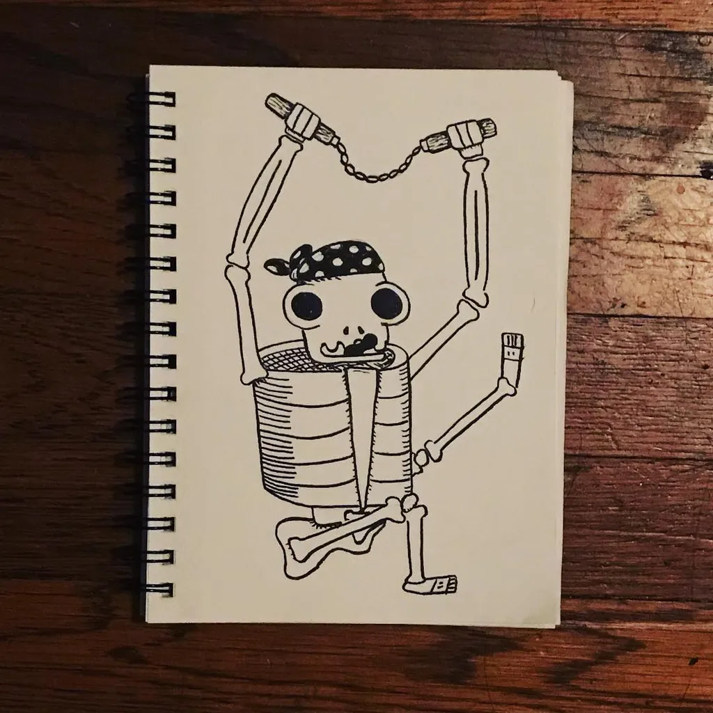 A black and white line drawing in a sketchbook depicts a striped, cartoon figure hanging by a chain from a horizontal bar, set against a dark wooden background.