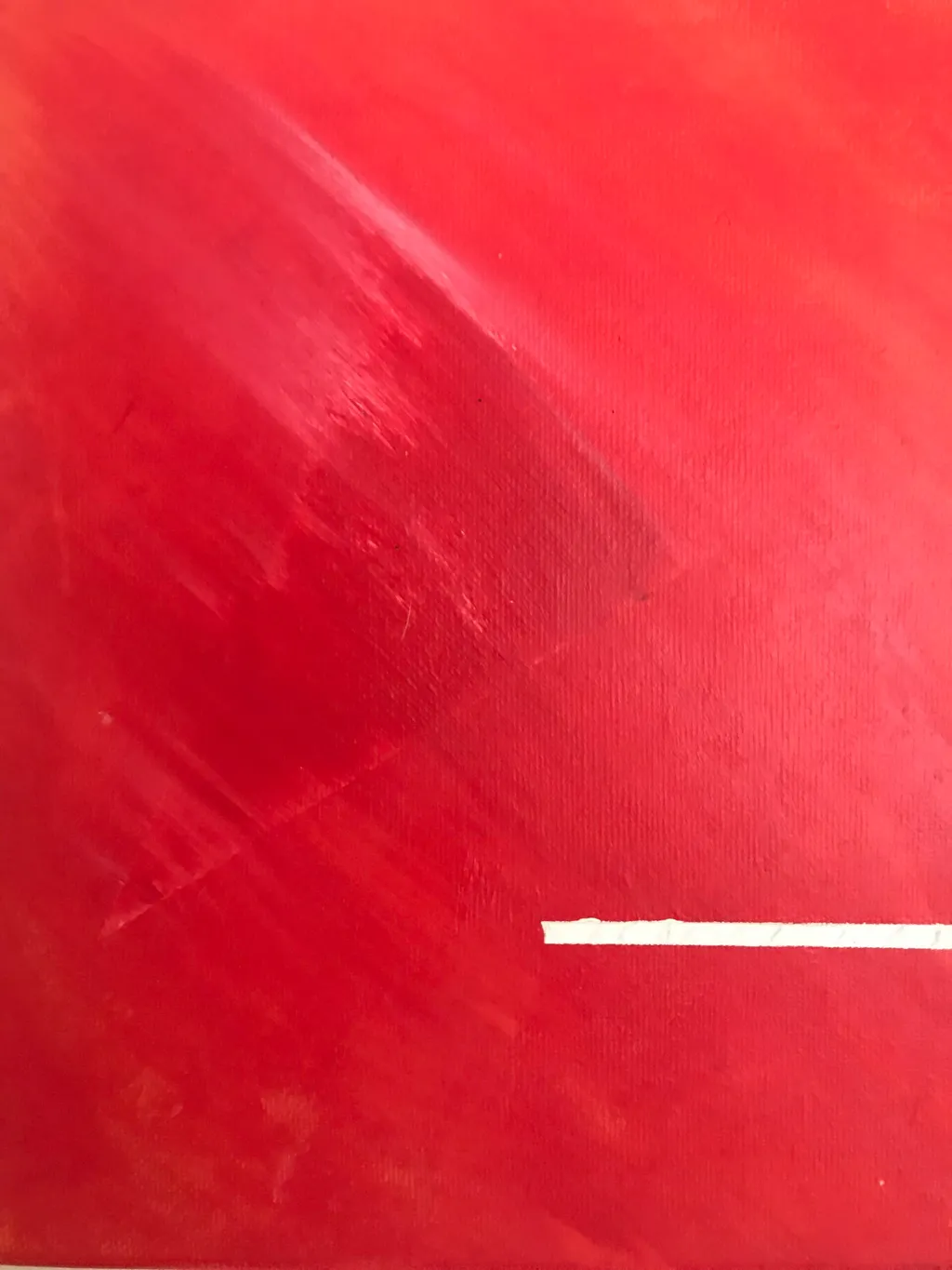 A field of deep red color showing visible streaks and broad, sweeping marks, contrasted by a stark, horizontal white line placed in the lower right quadrant.
