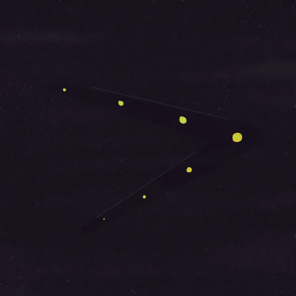 A dark, speckled background holds a bright yellow chevron shape, marked by a sequence of five smaller yellow dots arranged along its length.