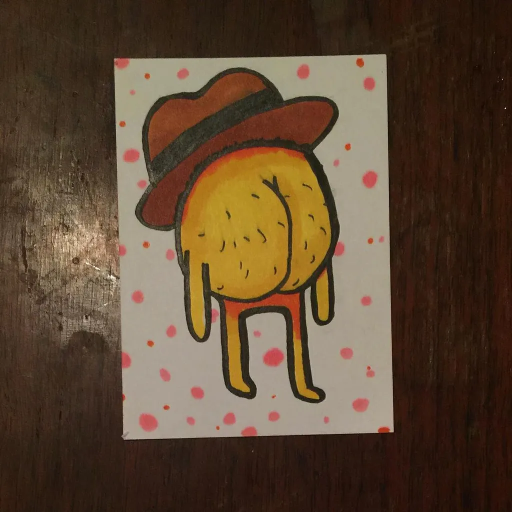 A drawing of a yellow, round creature wearing a brown hat and two thin legs, set against a white background speckled with pink dots.