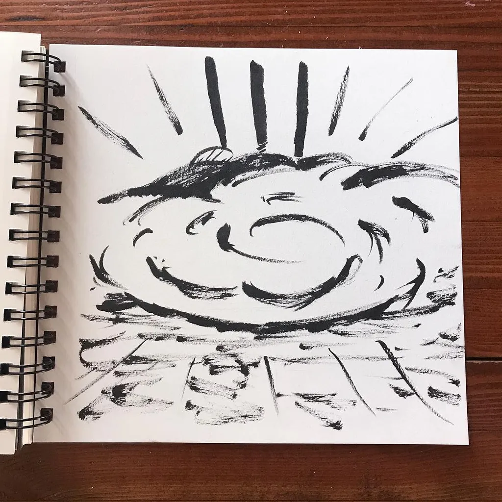 Black marks on white paper depict a stylized sun with radiating rays, featuring a central area of swirling, energetic curves above a sketched horizontal base.