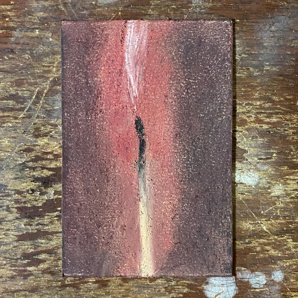 A vertical rectangle of deep reddish-brown and pink tones, marked by a central, dark vertical wash that transitions the color gradient across the textured surface.
