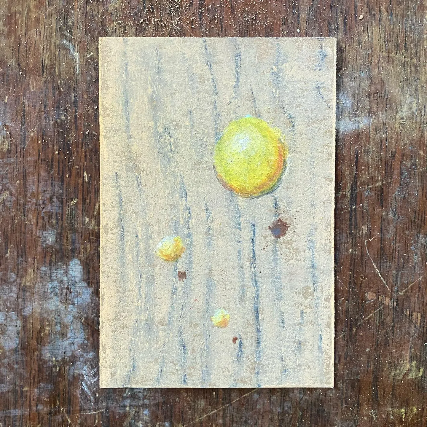 Vertical artwork on a pale, textured background with visible vertical streaks, featuring three yellow circles of varying sizes and scattered small dark spots.