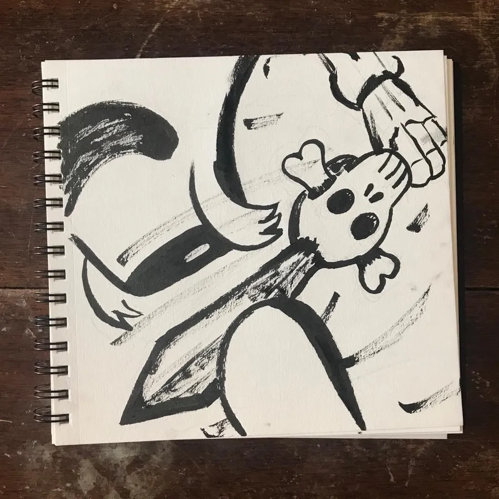 A stylized character drawing in black and gray pencil and ink, featuring a large tail and simple facial features, drawn on a page from a spiral sketchbook.