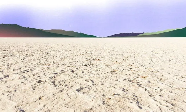 A flat, textured tan foreground leads to a distant horizon line where layered hills of varying greens meet a pale blue sky.