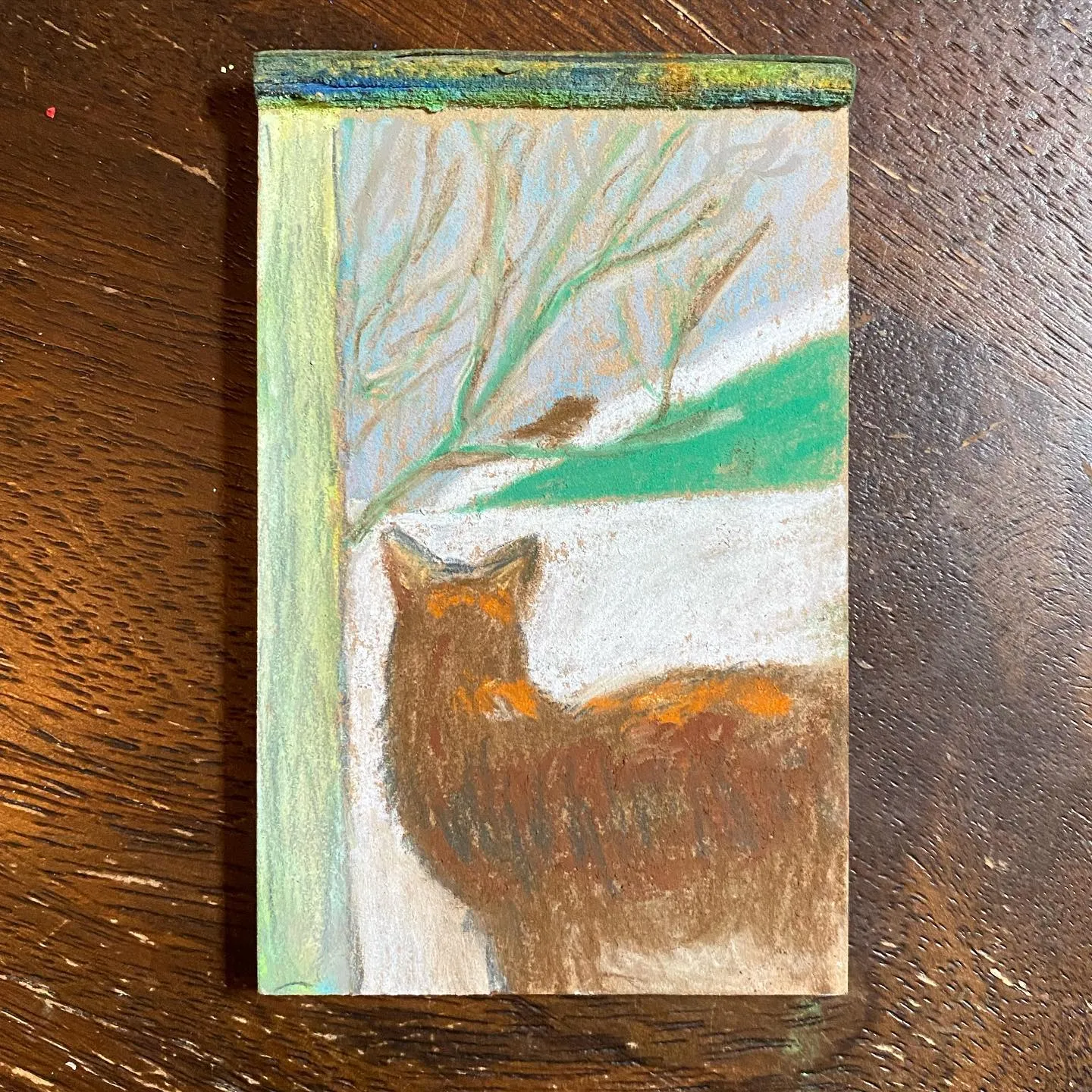 A vertical painting depicts a reddish-brown fox in the foreground against a background of pale blue and green, featuring the delicate, bare branches of trees.