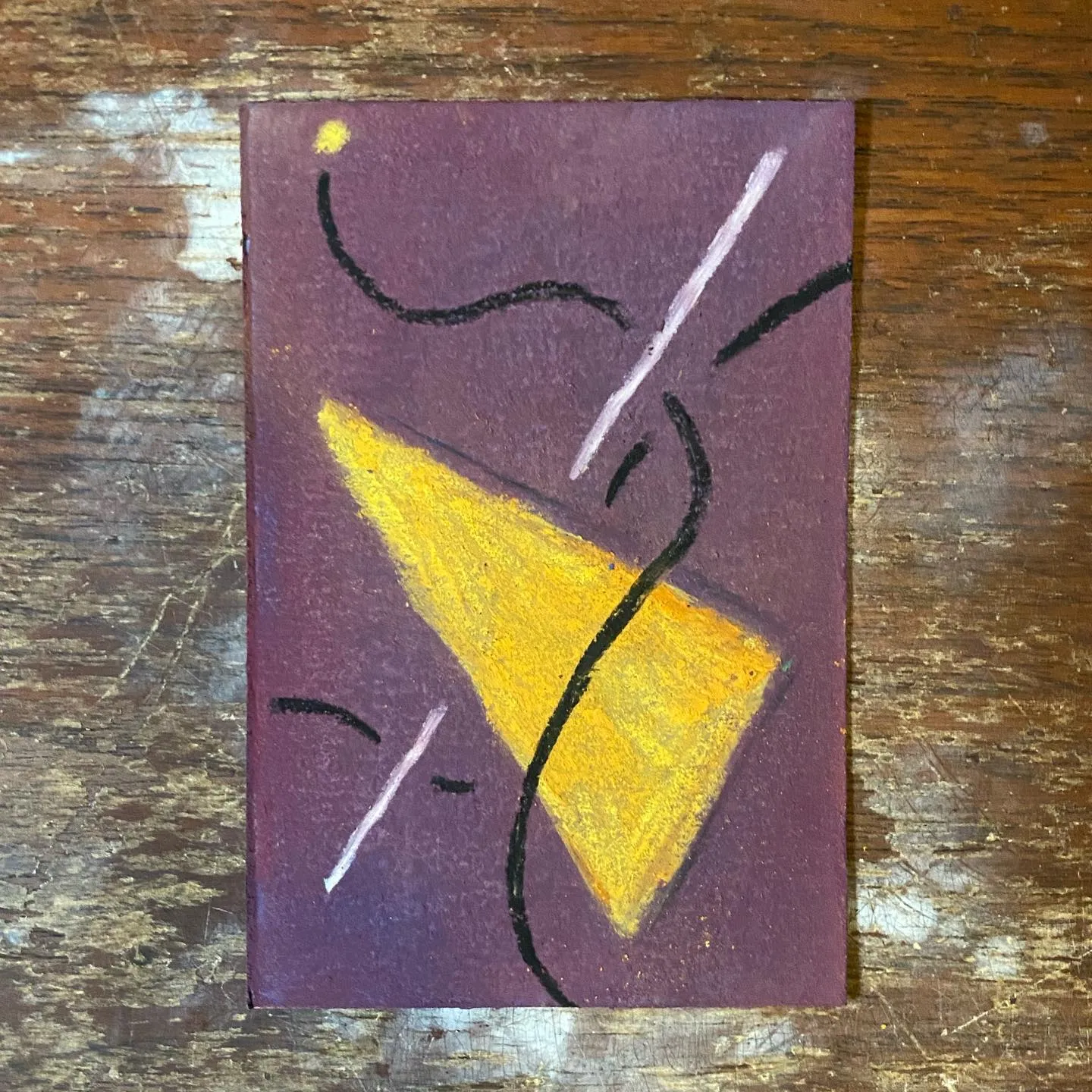 A yellow geometric shape is centered on a deep purple background, surrounded by thin black squiggly lines, white diagonal lines, and a small yellow dot in the upper left corner.