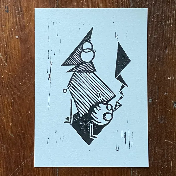Black ink drawing on white paper depicts a stylized, angular figure with a pointed hat, striped torso, and a lower head wearing glasses, flanked by sharp triangles, all set against a background of faint vertical scribbles.