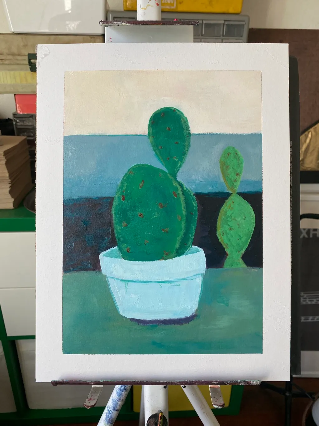 Three green cacti are painted in a light blue bowl against a background composed of horizontal bands of blue and dark blue, resting on a teal foreground.