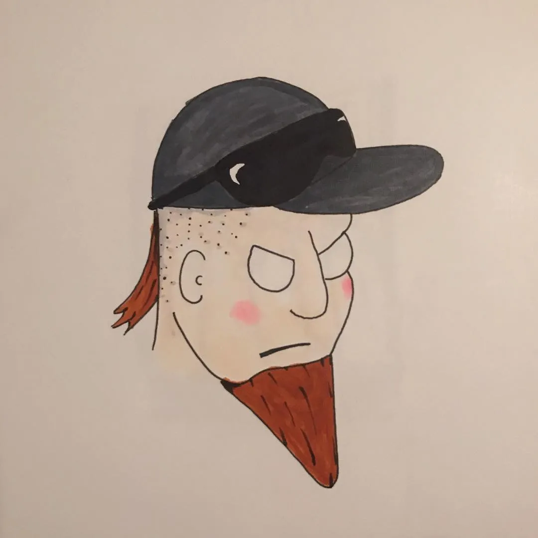A stylized portrait of a man wearing a dark baseball cap and sporting a reddish beard, featuring freckles, short reddish hair, and blush marks on his cheeks.