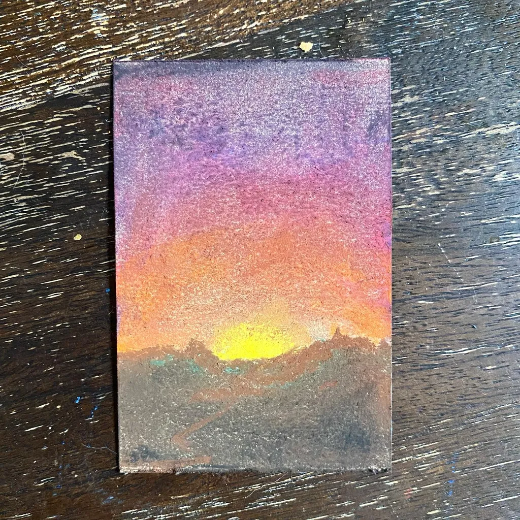 A vertical artwork depicts a sunset sky transitioning from deep purple at the top, through vibrant pinks and oranges, to a bright yellow glow above a dark, silhouetted foreground.