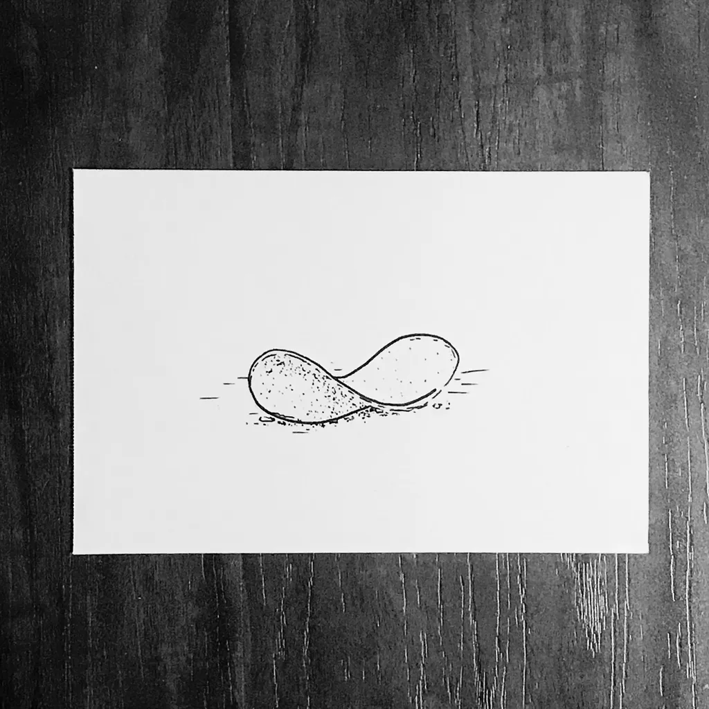 A simple black drawing of two connected, curved, wave-like shapes is centered on white paper, featuring small scattered dots beneath the lower curve.