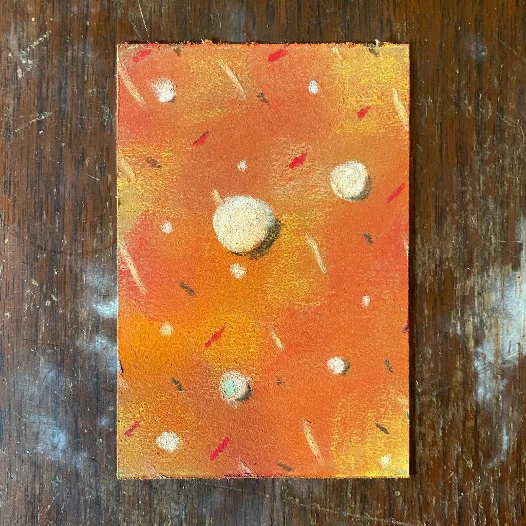 A square abstract painting features a gradient of orange and yellow tones, with scattered white and red marks and several circular white shapes.