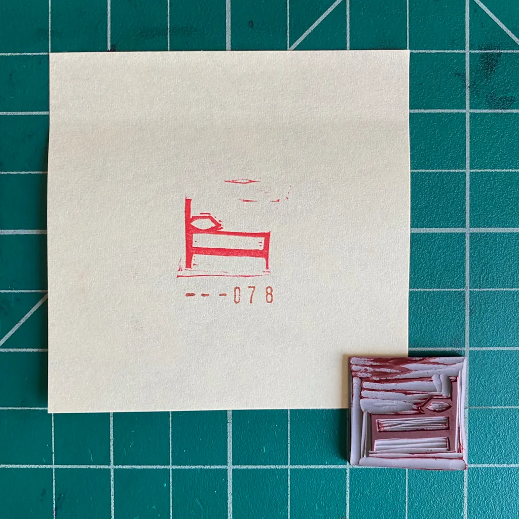 On a cream paper, a red drawing of a daybed and the numbers --078 appear next to a small, textured square composition of layered red and white rectangles, all placed on a teal grid.