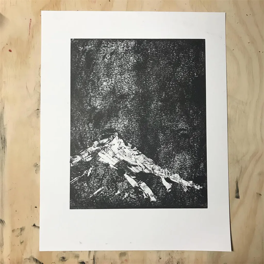 A monochromatic composition featuring a sharply defined, white mountain peak dominating the bottom third, set against a dense, speckled black background.