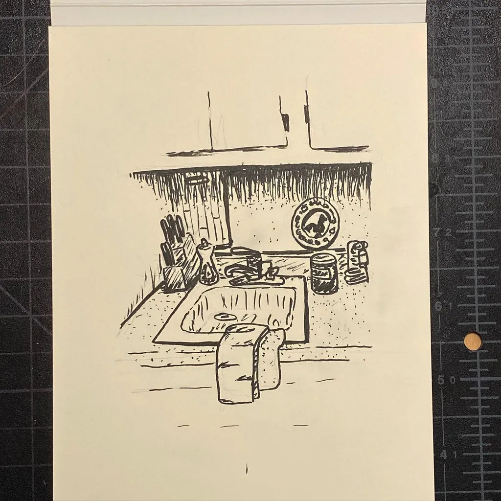 Linear black drawing depicting a simple domestic interior, showing a hearth counter with various objects and a large loaf of bread resting on the floor.