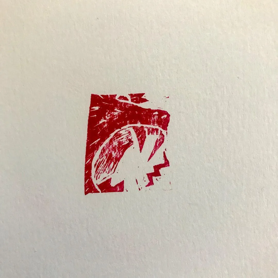 A distressed red rectangular mark is centered on white, containing a stylized, angular zigzag shape.