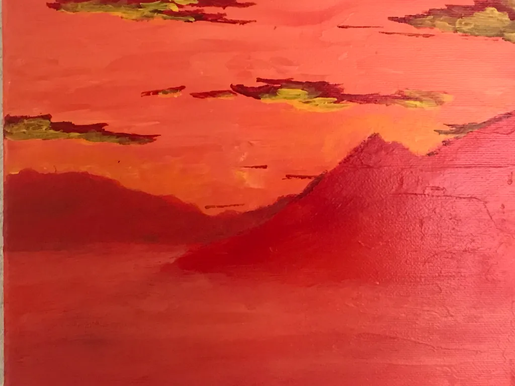 Warm reds and oranges dominate the composition, depicting a sunset over dark, layered mountains and a smooth, textured sky.