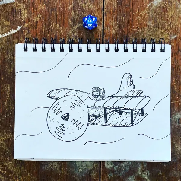 A black ink drawing on white paper depicts a stylized creature and a boat-like scene, with a blue and white die resting on the page atop a dark wooden surface.