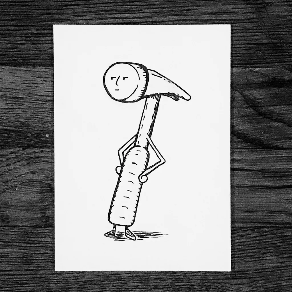 A black line drawing on white paper depicts a stylized figure with a hammer head for a head and a cylindrical body, standing on a dark wood surface.
