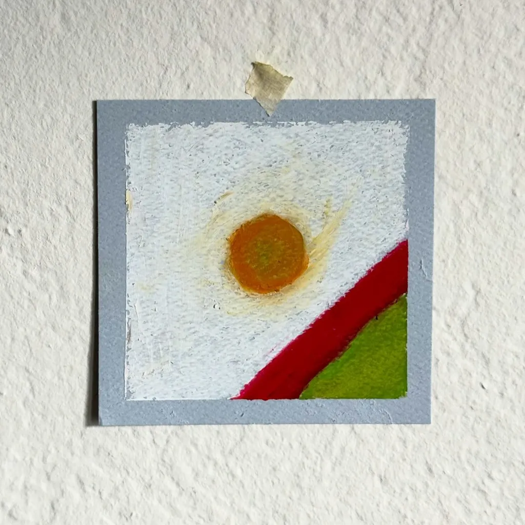 A square composition features a yellow sun with radiating white lines on a white background, positioned above a diagonal band of red and green color.