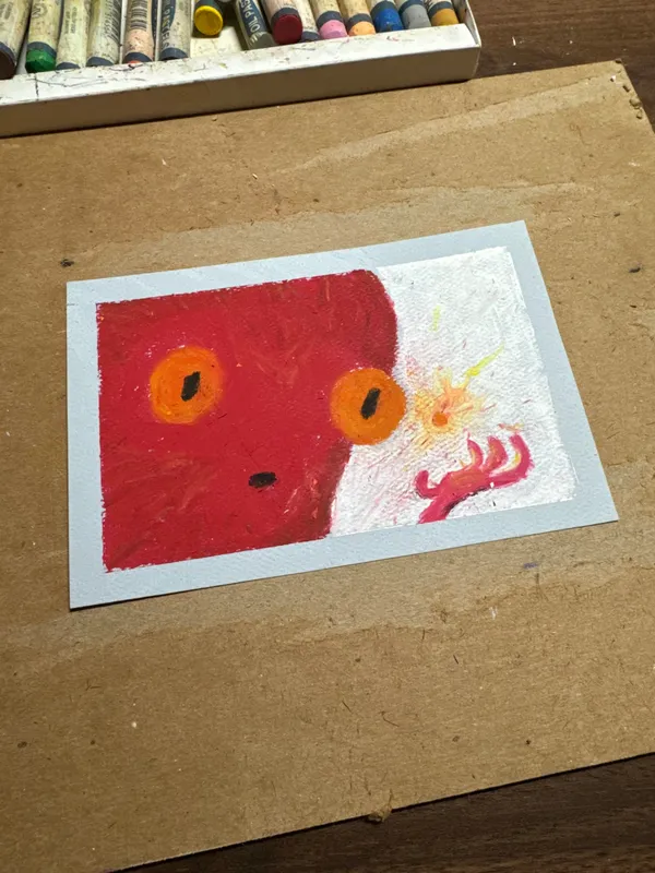 A red, stylized face with large orange eyes and a small mouth is drawn on white paper, balanced by red and white marks depicting a tentacle-like form on the right.