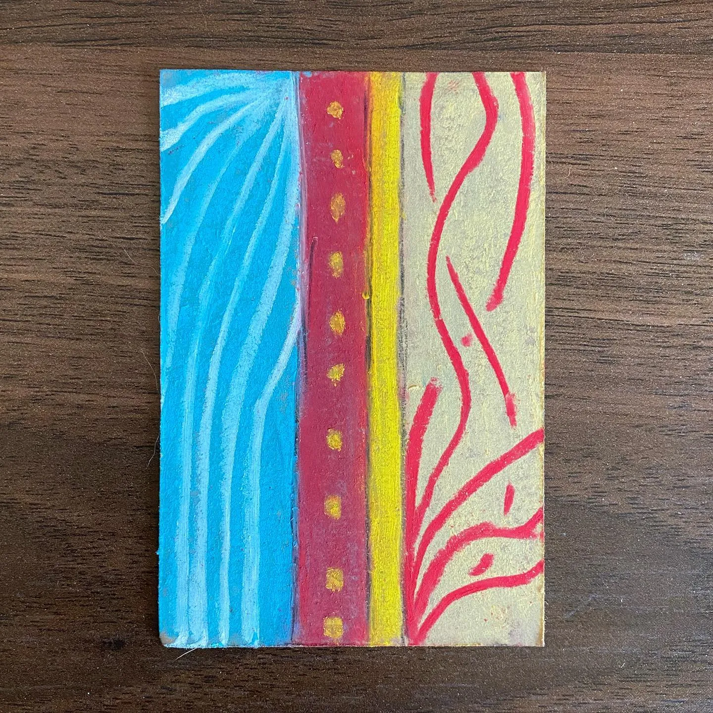 Five vertical panels feature alternating stripes of blue, deep red, and bright yellow, concluding with a pale background marked by several irregular red branches.
