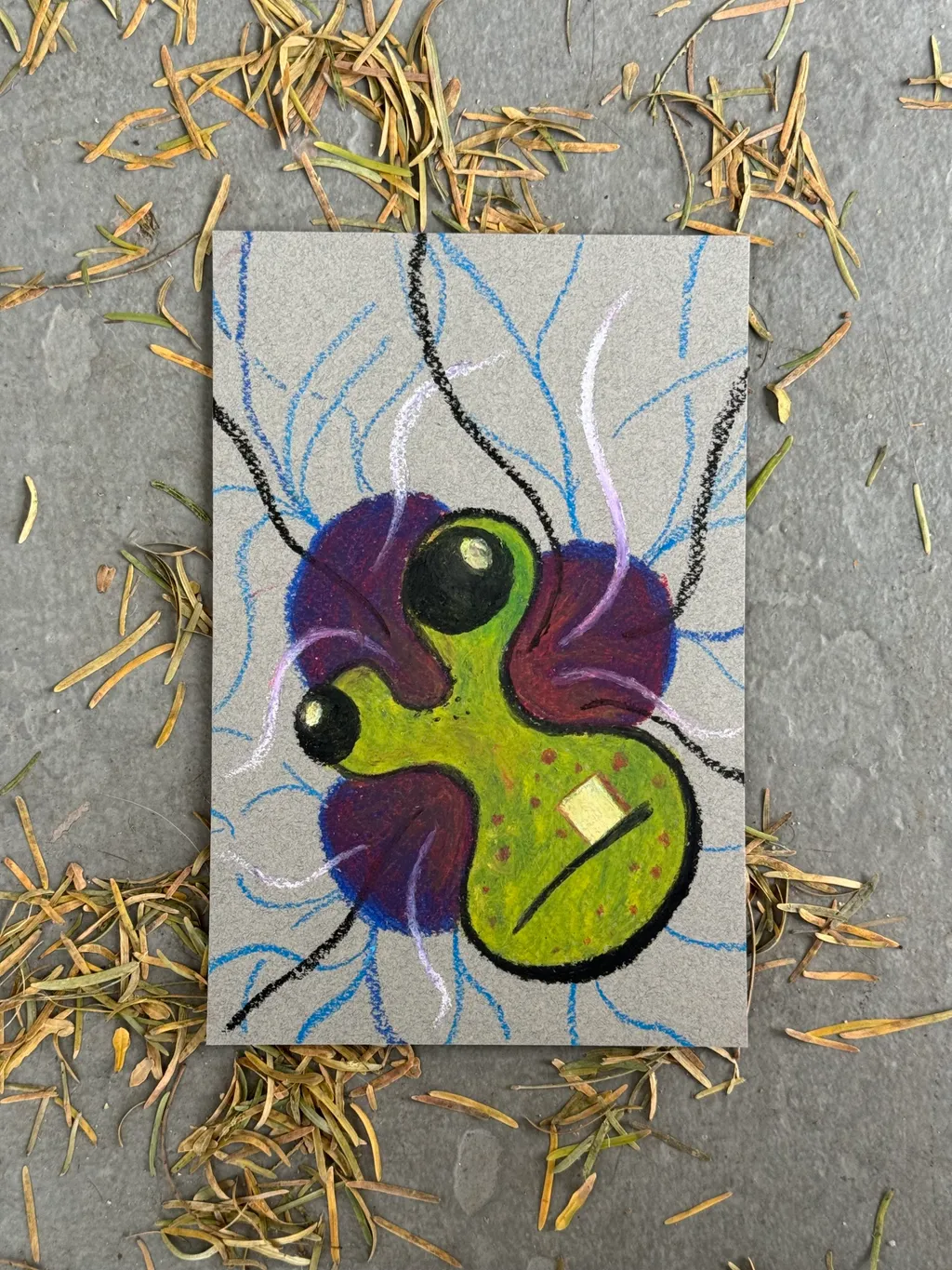 A cartoonish insect, colored purple and lime green, is centered on light gray paper, accompanied by delicate blue lines that radiate and crisscross the background.