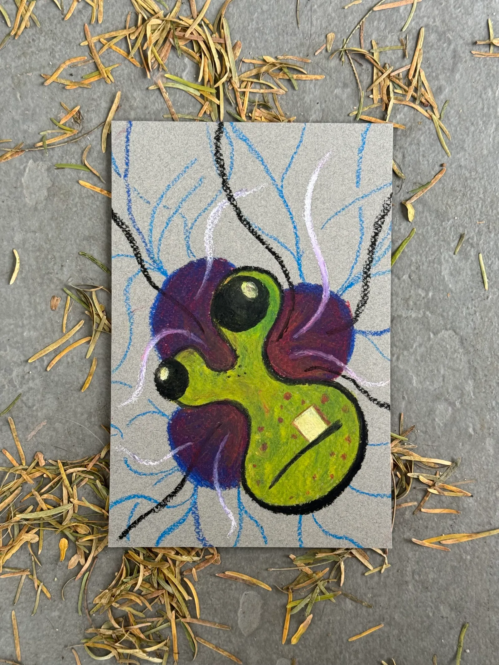 A cartoonish insect, colored purple and lime green, is centered on light gray paper, accompanied by delicate blue lines that radiate and crisscross the background.