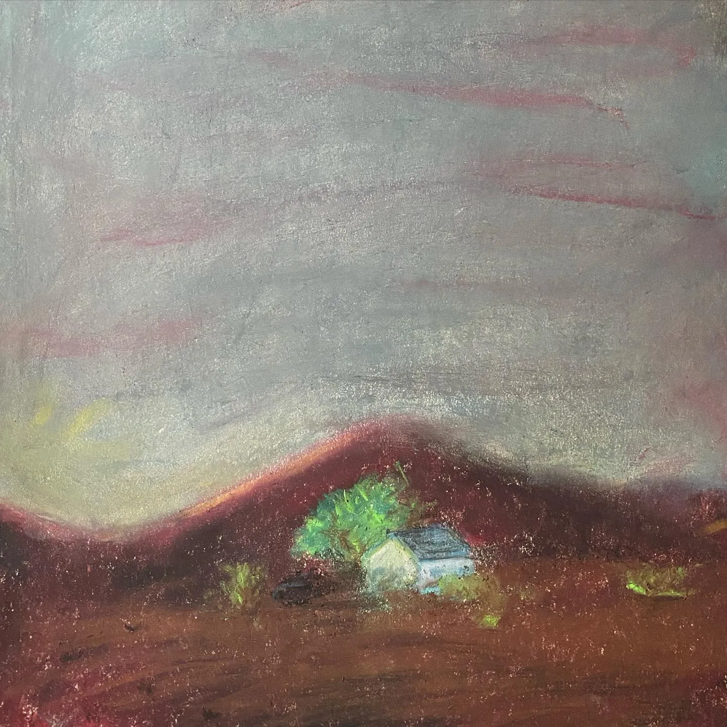 A landscape composition featuring rolling hills of deep red and brown under a muted gray and pale pink sky, with a small light blue house and green foliage situated in the dark foreground.