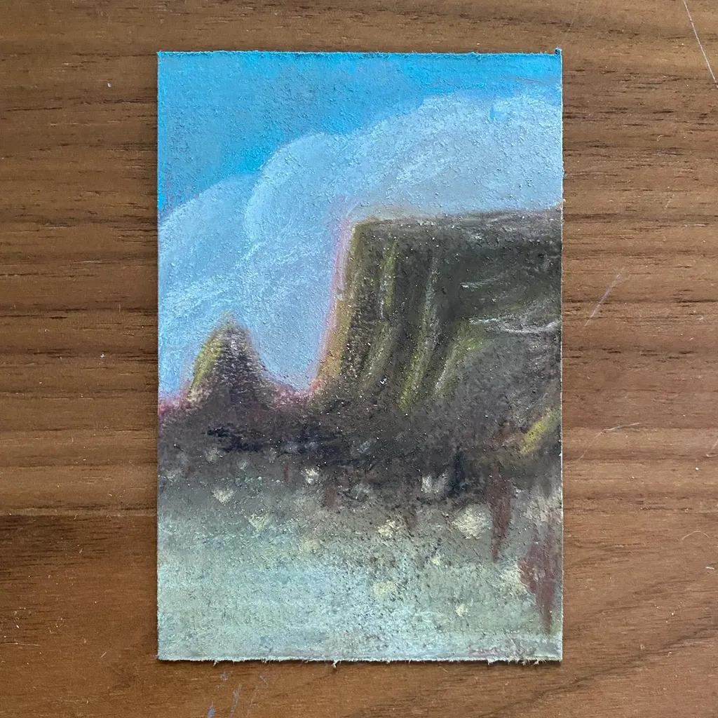 A landscape composition featuring massive, dark green and brown rock formations under a bright cyan sky with white clouds, resting on a pale yellow-green foreground.