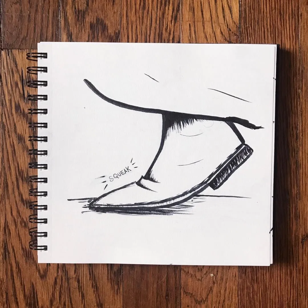 Black line drawing of a pair of stylized shoes in motion, accompanied by the text SQUEAK, drawn on white paper resting on a wooden surface.