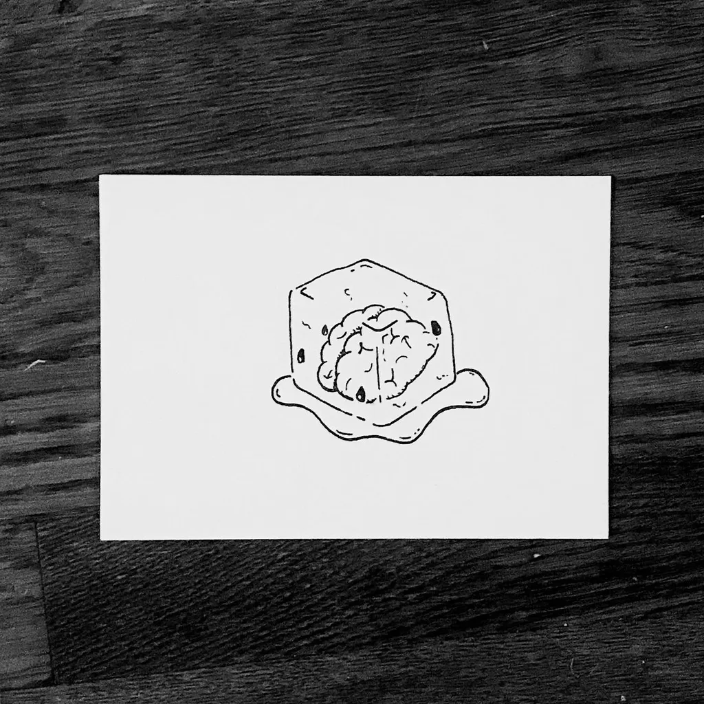 A black line drawing depicts a brain resting on a square, irregular plate, centered on white paper placed on a dark wooden surface.