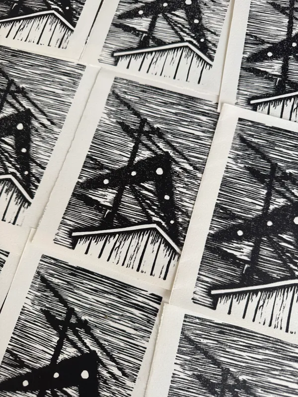 A grid of small, black and white prints featuring repeating geometric motifs of gabled houses and intersecting lines over a dense, horizontally striped background.