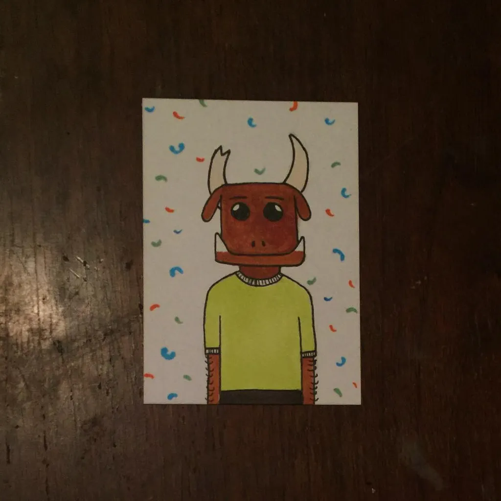 A cartoon bull figure with brown horns and face wears a light green sweater, set against a white background speckled with small red, blue, and green dots.