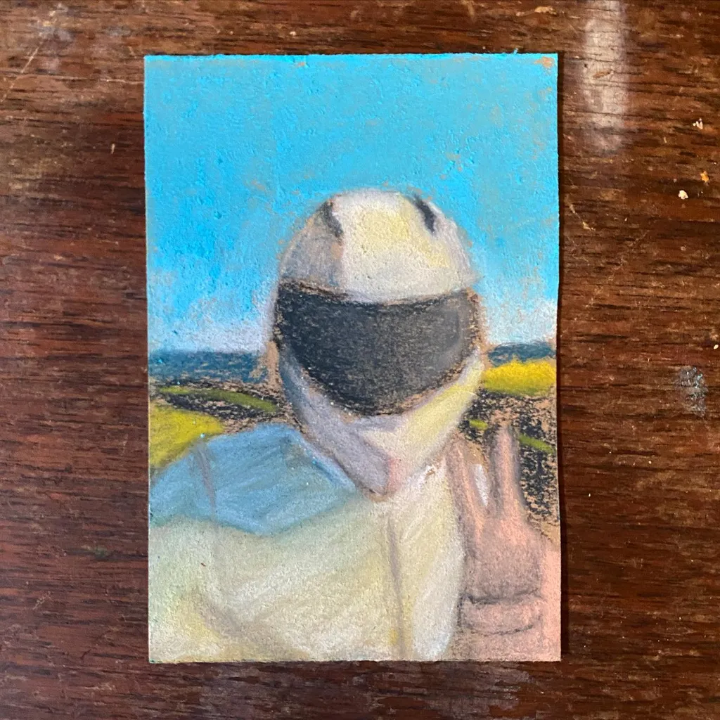 A portrait depicts a person wearing dark goggles and a light suit, making a peace sign, set against a bright blue sky and a yellow-green horizon line.