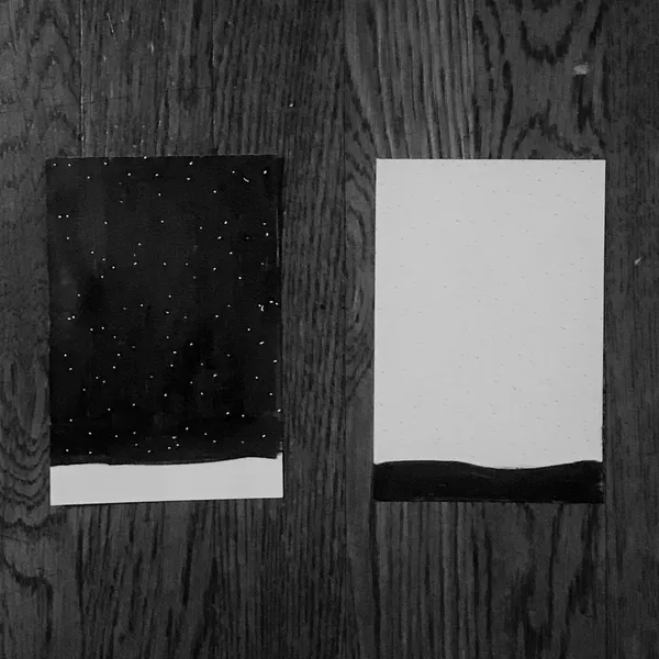 Two rectangular panels are displayed side by side: the left panel is dark with scattered white dots and a white lower band, contrasting with the right panel, which is white with a solid black lower band.