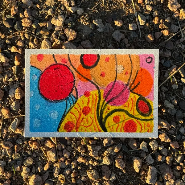 The abstract artwork uses bold shapes and patterns in red, blue, yellow, orange, and pink, creating a dynamic composition of overlapping circles and curved lines.
