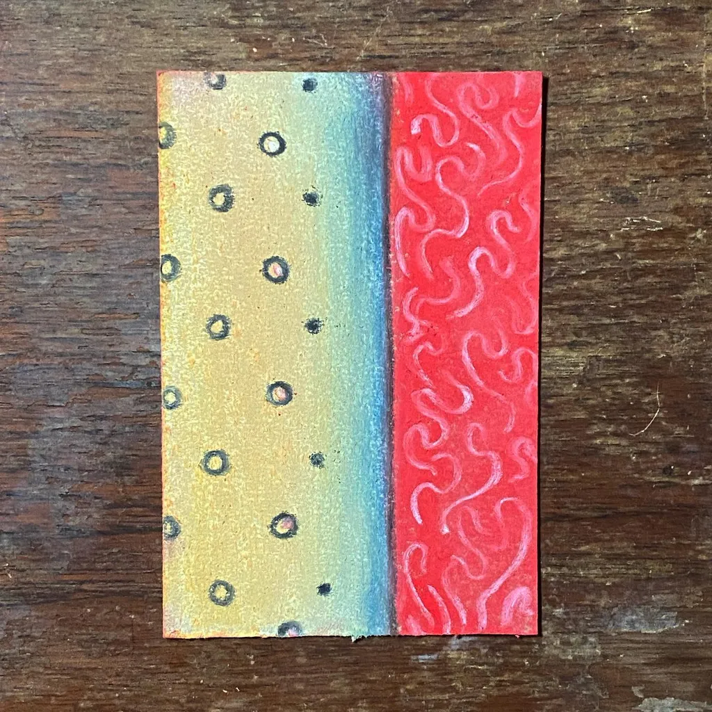 A rectangular artwork on wood shows a yellow section with dark dots fading into pale blue, next to a solid red section covered in continuous wavy white lines.