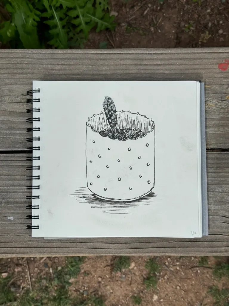 A black and white sketch shows a glass filled with dark, textured sediment and several small, scattered dots in the liquid.