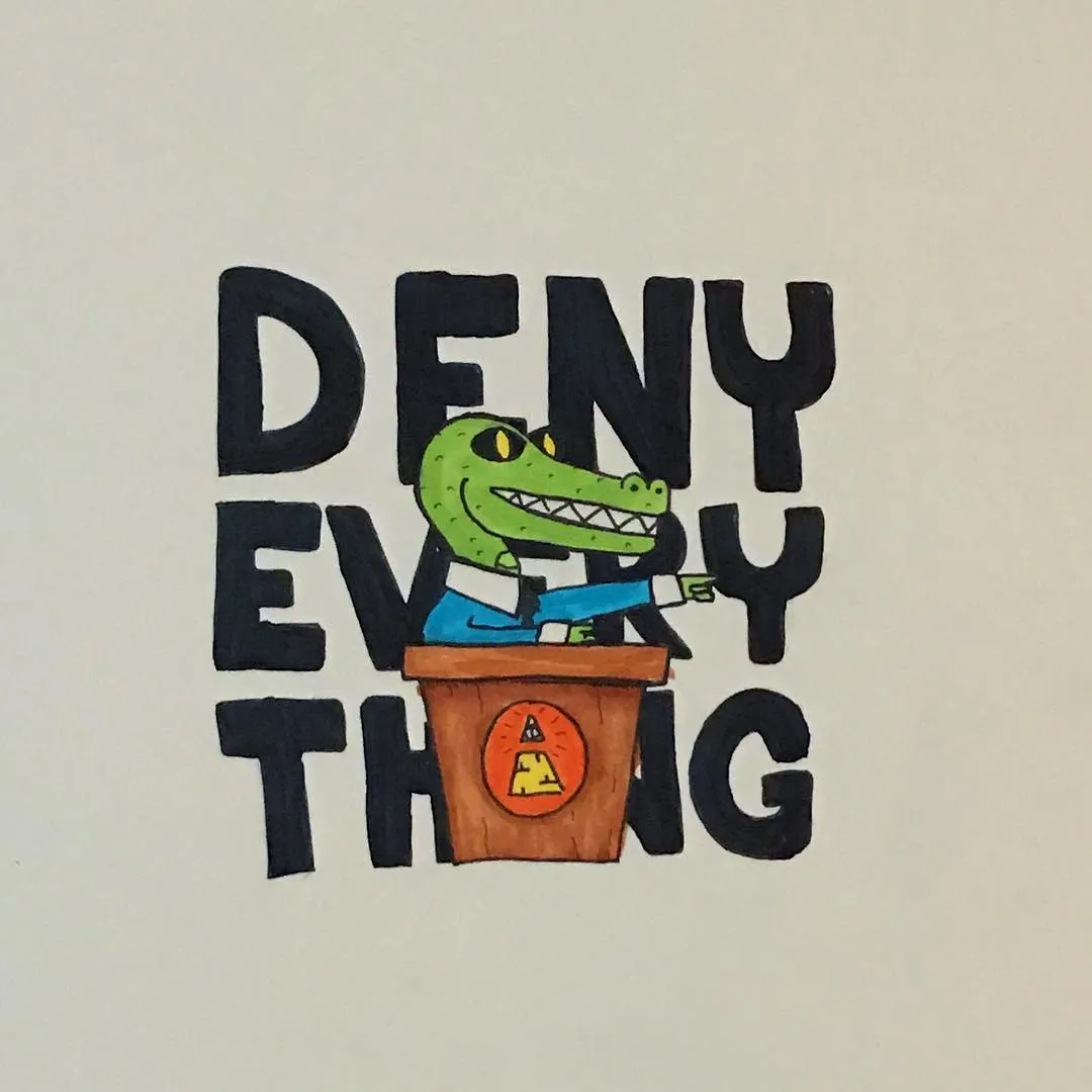 A green cartoon alligator sits in a brown box with an orange symbol, surrounded by large black block letters that spell DENY EVERY THING.