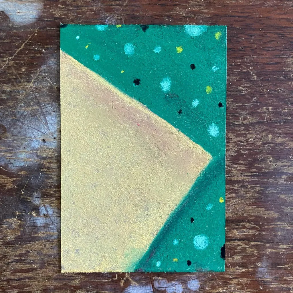 A rectangular artwork divided diagonally into a pale yellow section and a deep teal section, the teal side featuring scattered spots of blue, yellow, and black.