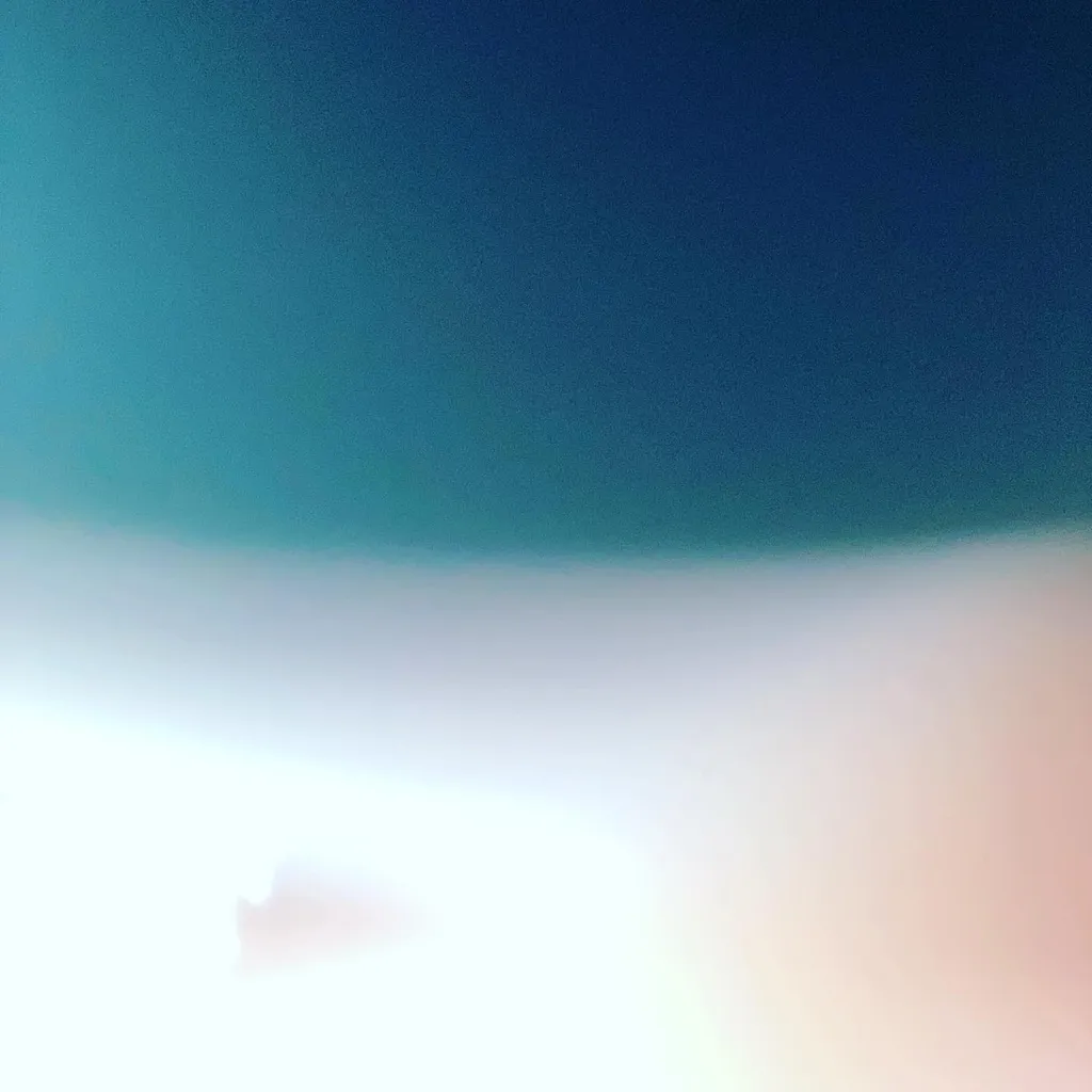 The composition is divided horizontally, showing deep teal above a soft gradient of blue and white, which transitions into a bright, pale pink and white foreground.