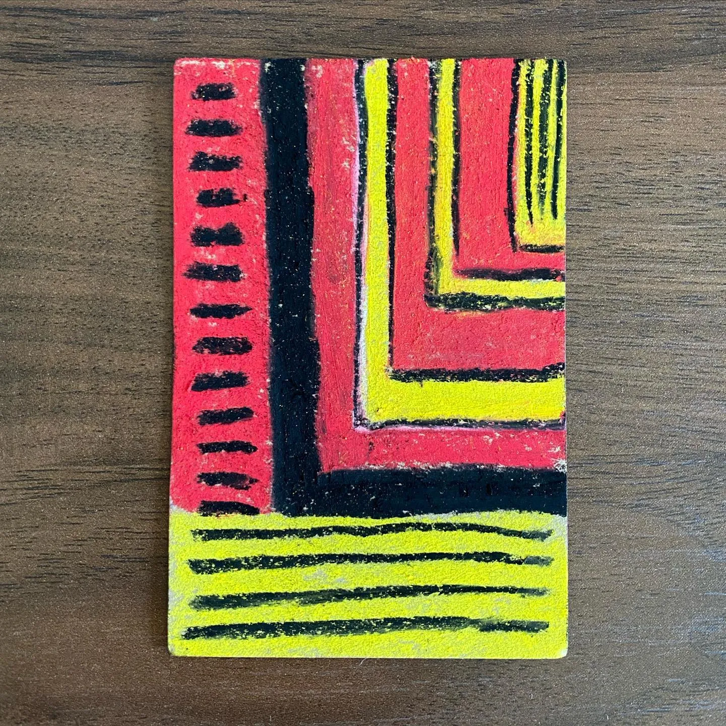 Bold abstract composition featuring vertical red and black stripes on the left, adjacent to nested yellow and red rectangles, all resting above horizontal yellow lines.