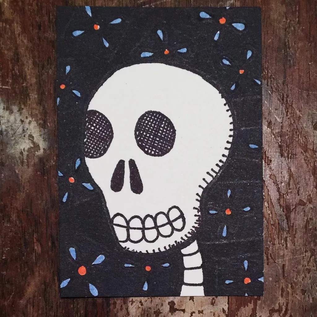 A stylized white skull with black outlines is centered against a dark background filled with scattered blue and orange abstract floral shapes.
