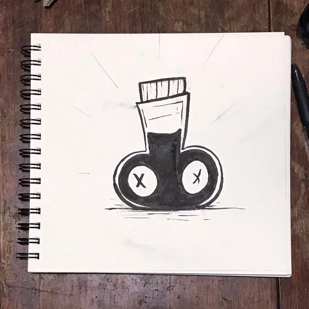 A black ink drawing on white paper depicts a stylized object resembling a shoe or container with two circular openings, and a rectangular element on top.