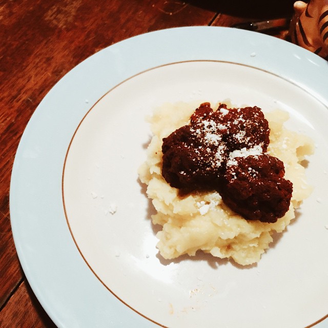 Chorizo meatballs on mashed potatoes with cotija cheese.